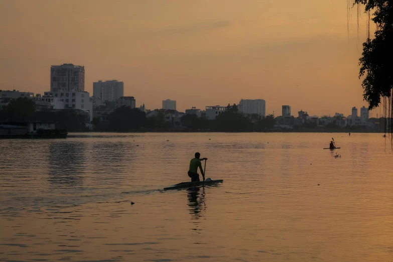 a person rowing a long canoe in the water