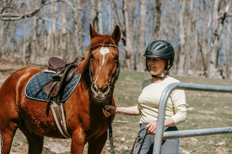 a woman with a helmet on and her horse