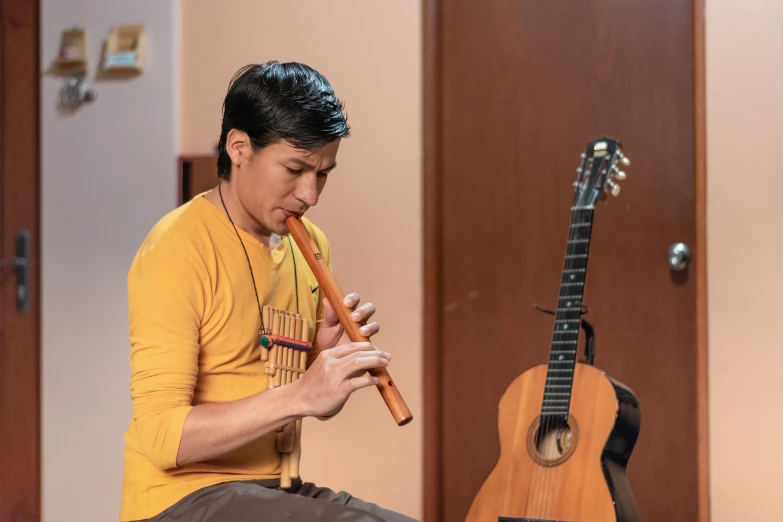 a person that is playing on a tiny ukulele
