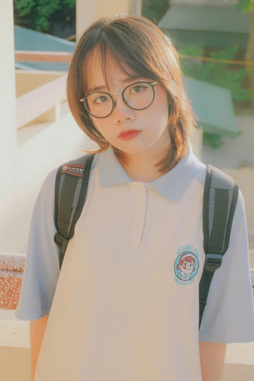 a girl with glasses and a school uniform standing by stairs