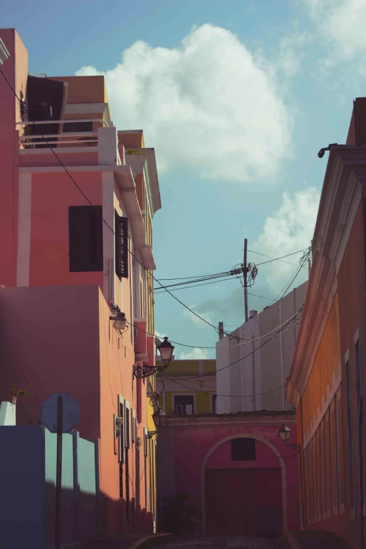 a couple of pink buildings on a road