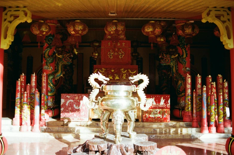 a small fountain in a large room with statues and pillars