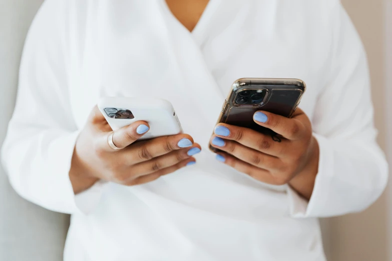 a person using a cell phone with both hands