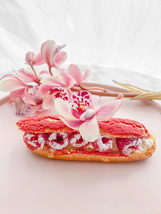 a pink flower is placed in a sandwich