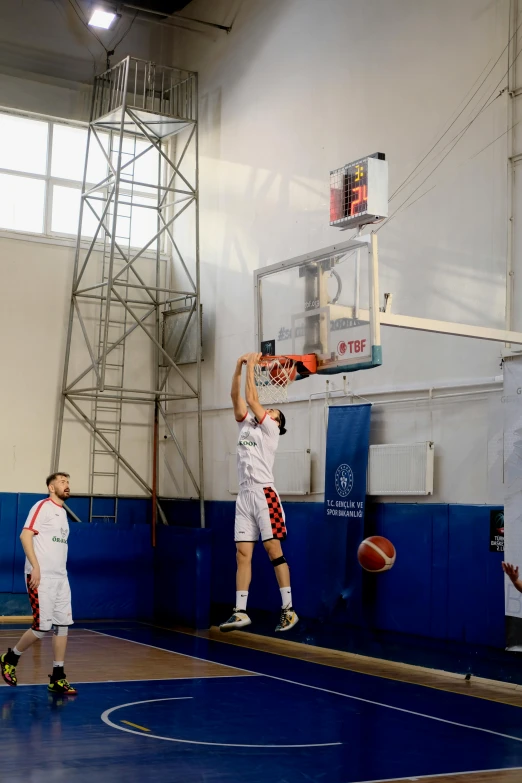 a man that is in the air with a basketball