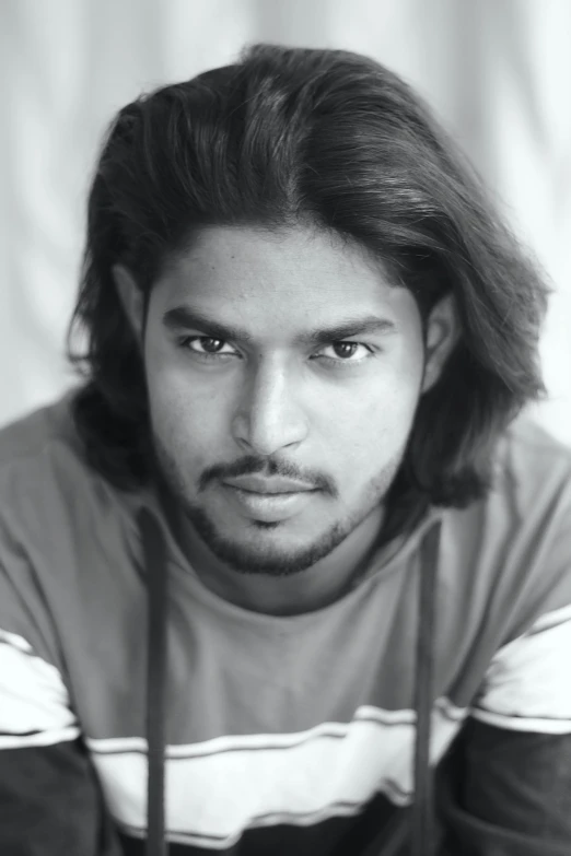 black and white pograph of a man in striped shirt