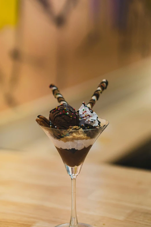 a cup filled with toppings on top of a wooden table