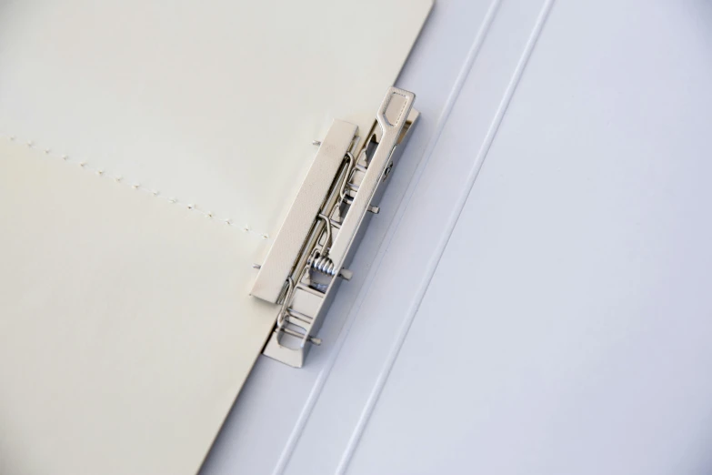 a white folder sits open with a binder and a pad