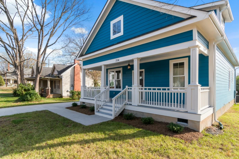 a blue and white house on a green yard