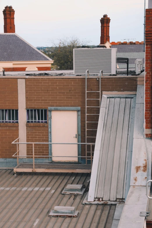 two metal structures sit in the middle of an empty rooftop