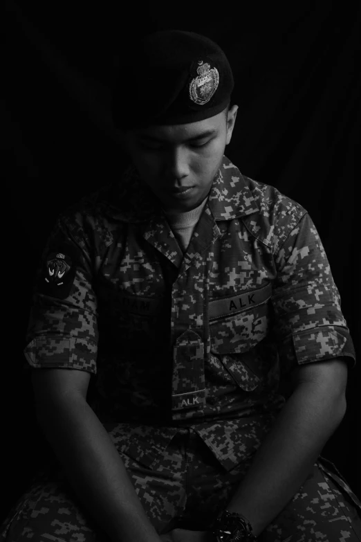 the boy wearing a helmet sits cross legged