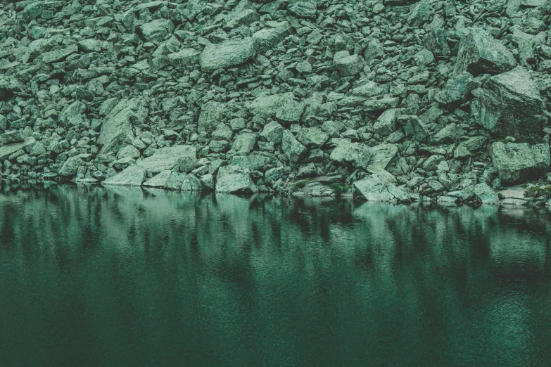 a rocky area with water and rocks on the side