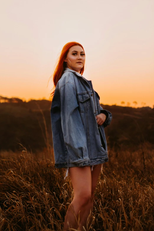 a woman is standing in the grass