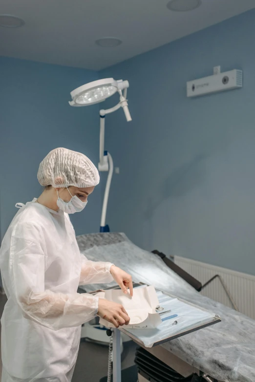 a surgeon in an operating room doing soing on a sheet