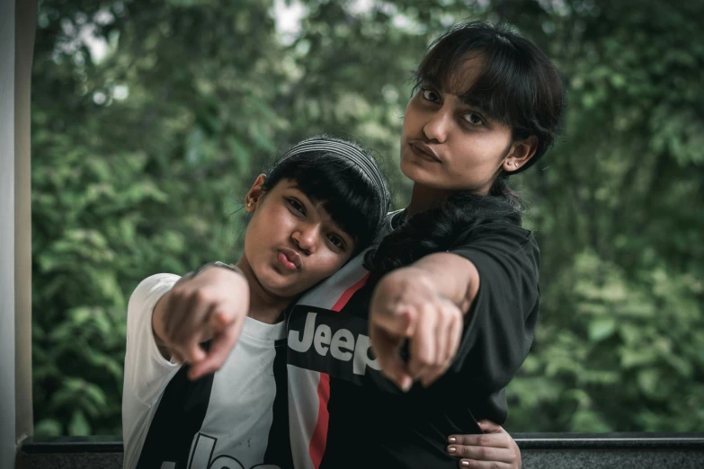 two boys pointing at soing while wearing white and black outfits