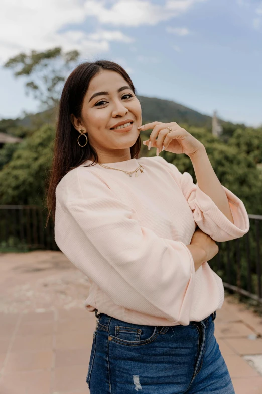 a woman with a smile on her face, standing outdoors