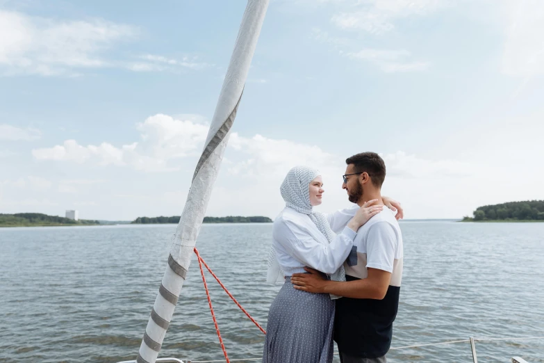 two people standing on a boat looking at the water