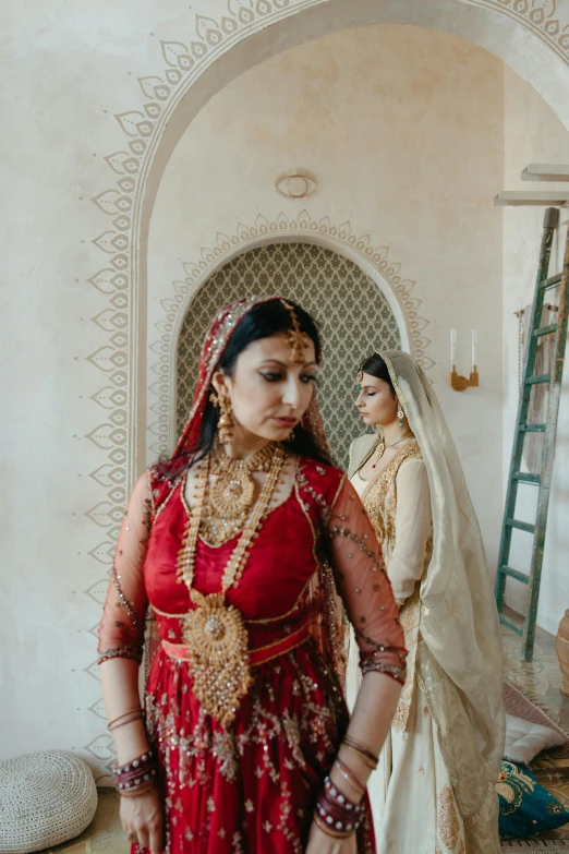 a bride standing in front of her indian groom