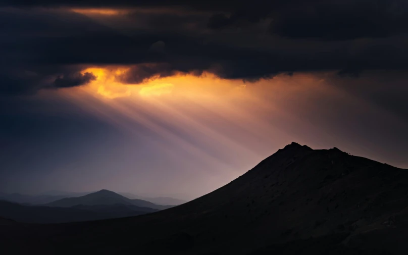 the sun is shining down on a large mountain