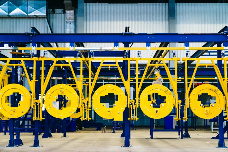 a yellow and blue structure with yellow pipes attached to it