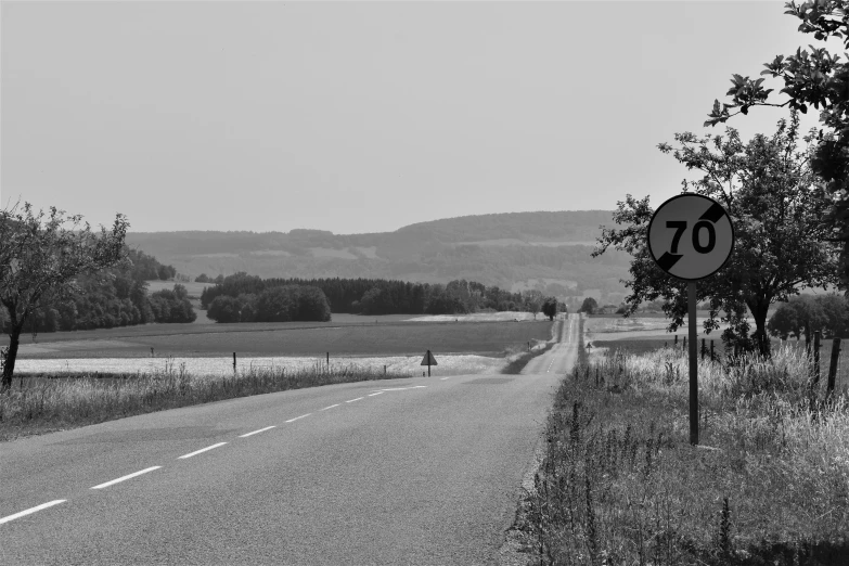 a black and white po shows an empty highway