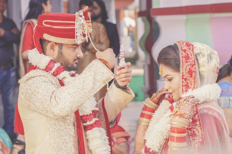 the couple is getting ready to tie their wedding rings