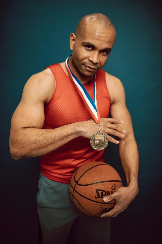 an athlete with his basketball and gold medal