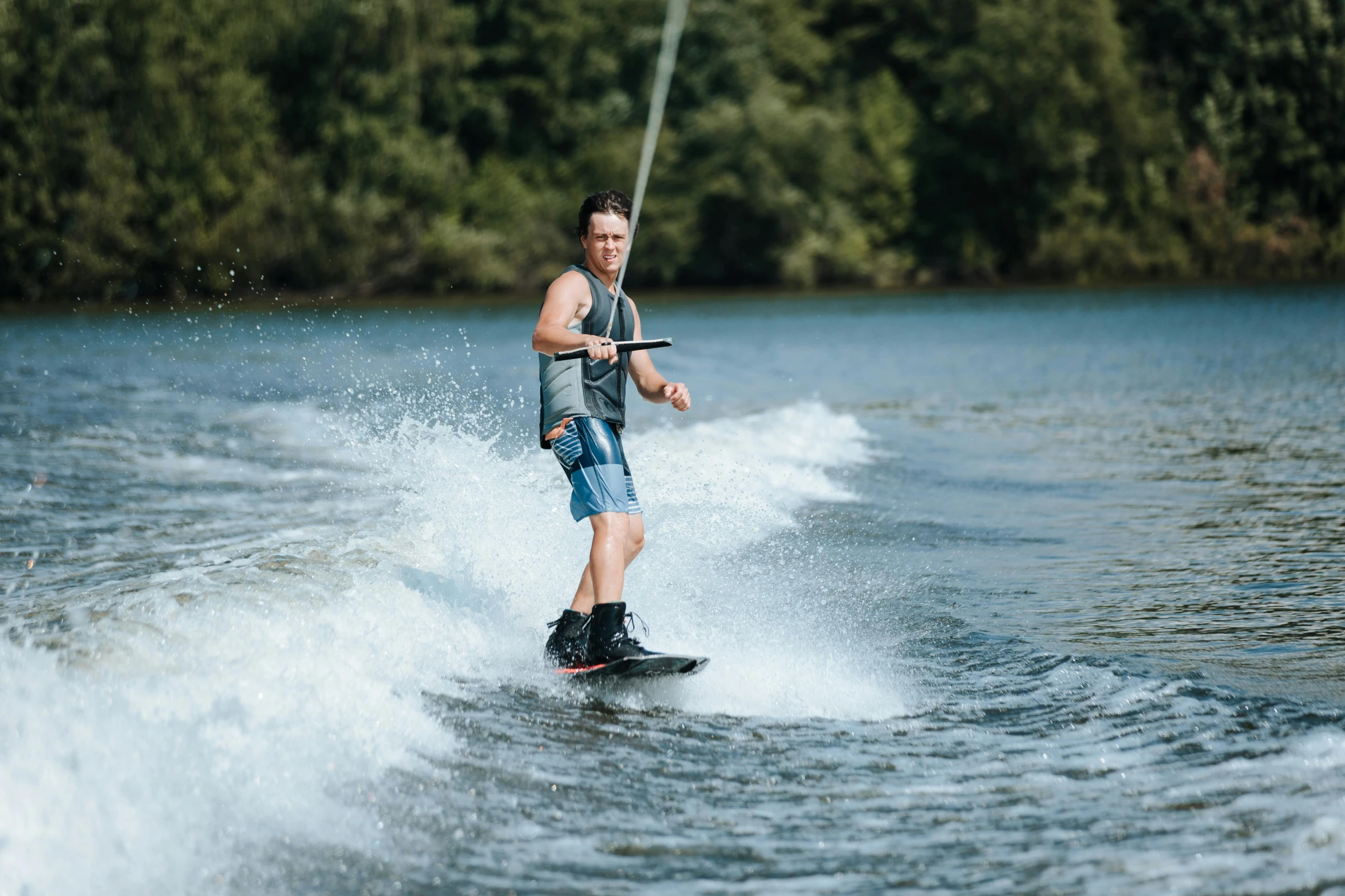 a man in jeans water skis on water