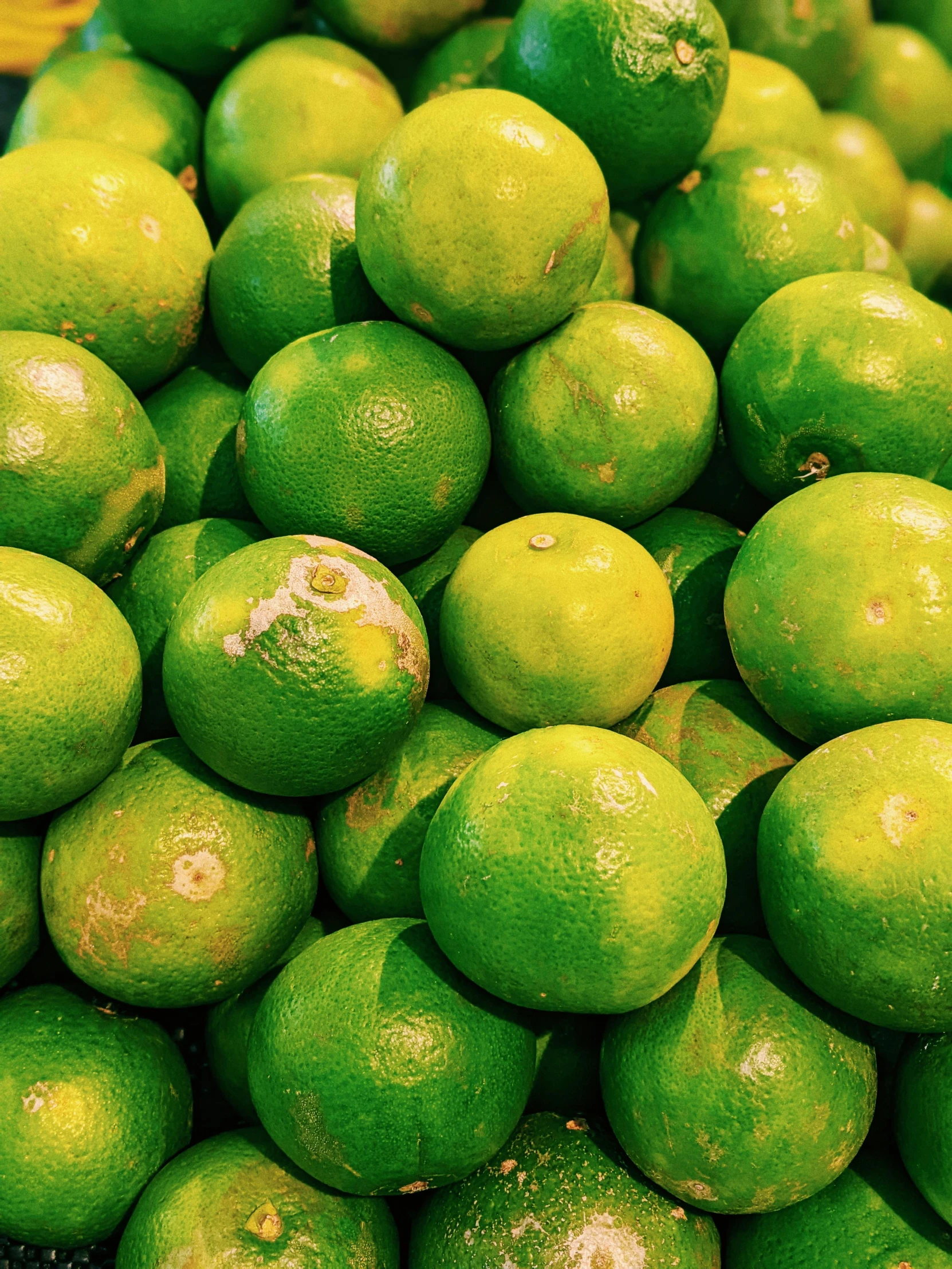 there is a large bunch of limes sitting next to each other