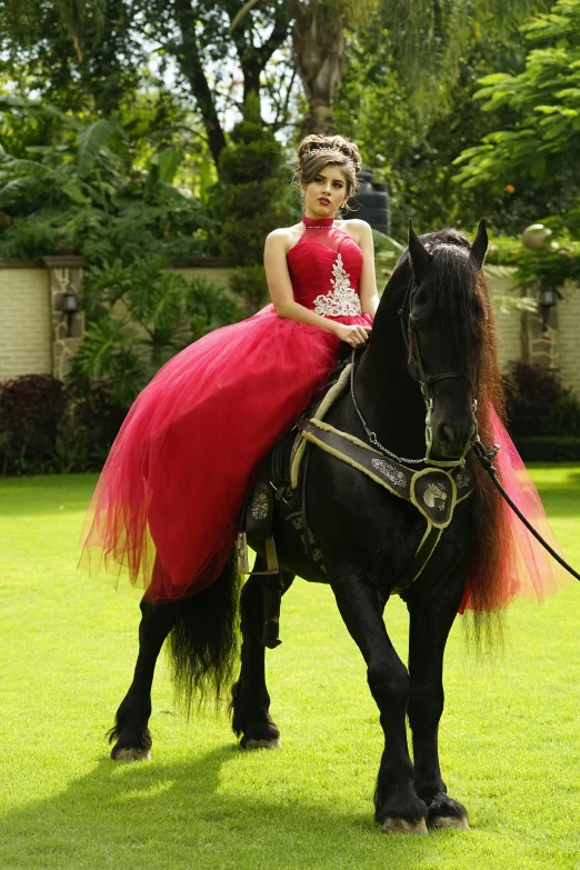 the young woman is riding her horse in the field