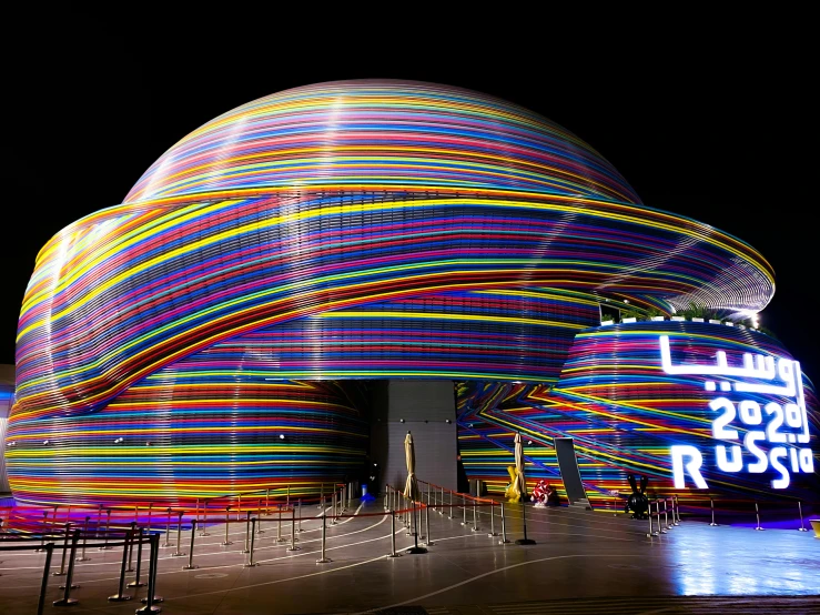 a building covered in lights is illuminated up