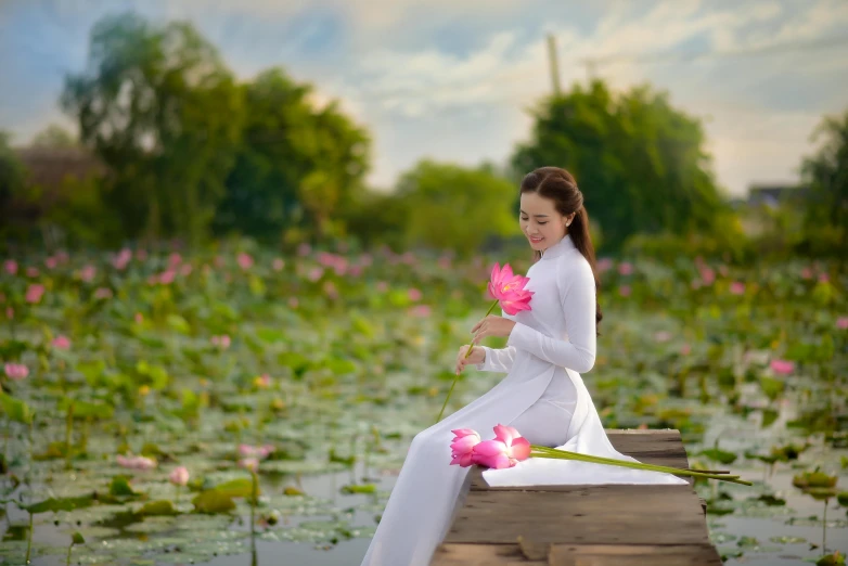 a beautiful woman with white clothing and pink flowers