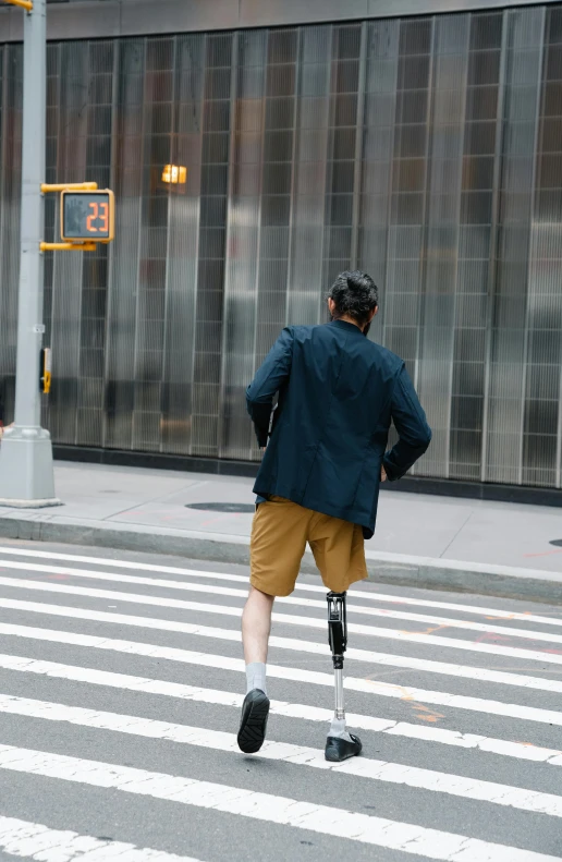 a man with crutches walking across the street