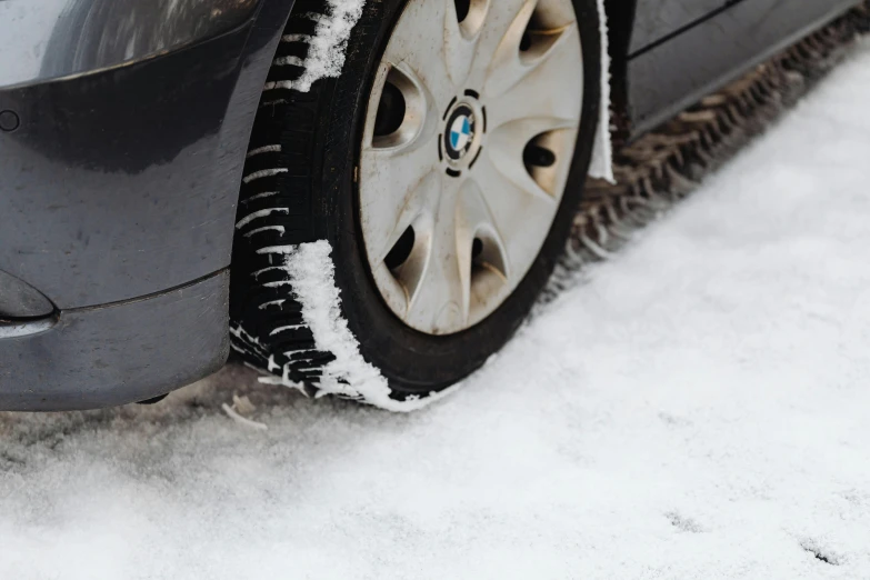 a tire and snow are seen on the front of a car