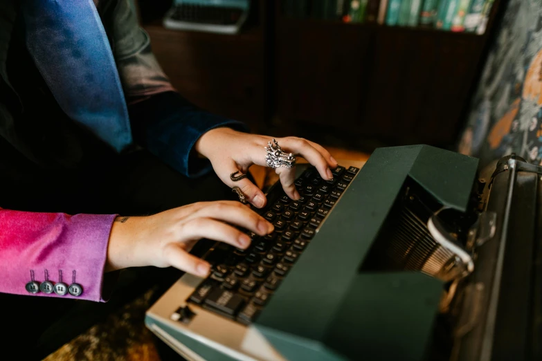 a person using a computer on top of a wooden table