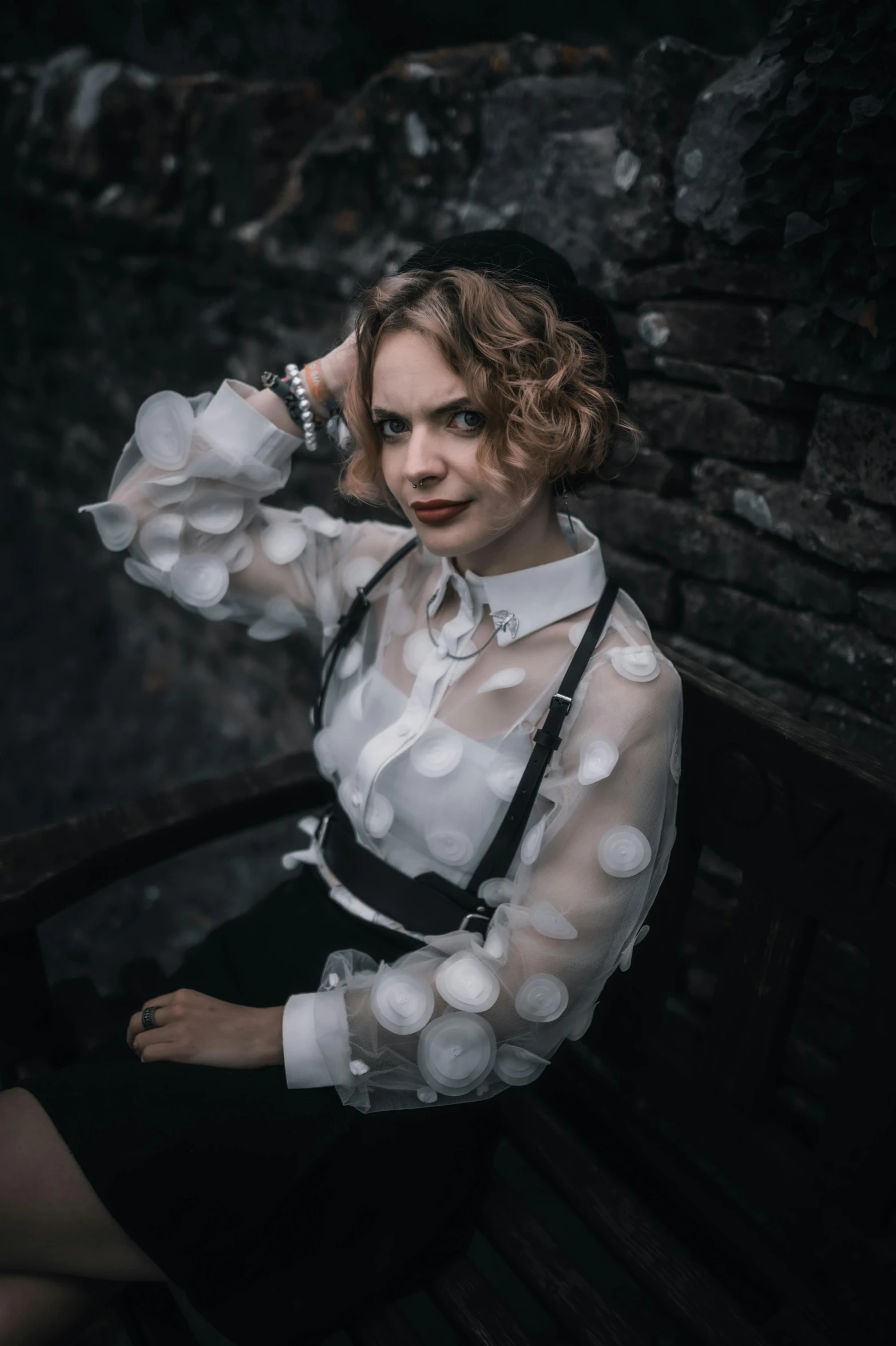 young lady sitting on a bench wearing polka dots and a black dress