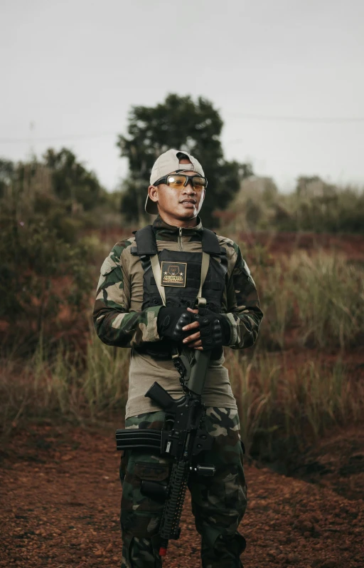 a person standing in the dirt with a rifle