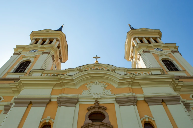 a church with a tall tower and clocks on top