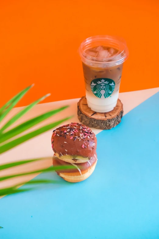 two cookies and starbucks coffee sit on a table