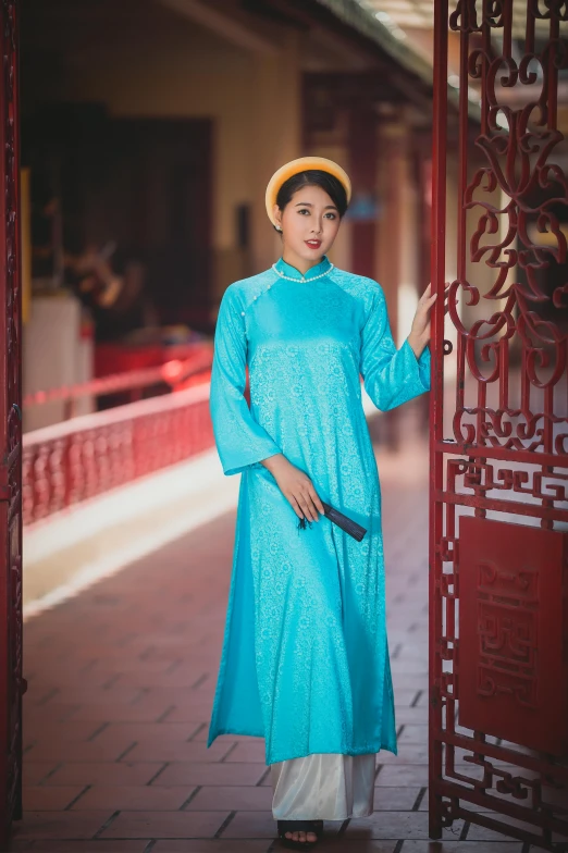 a woman with short blue hair wearing a dress and hat