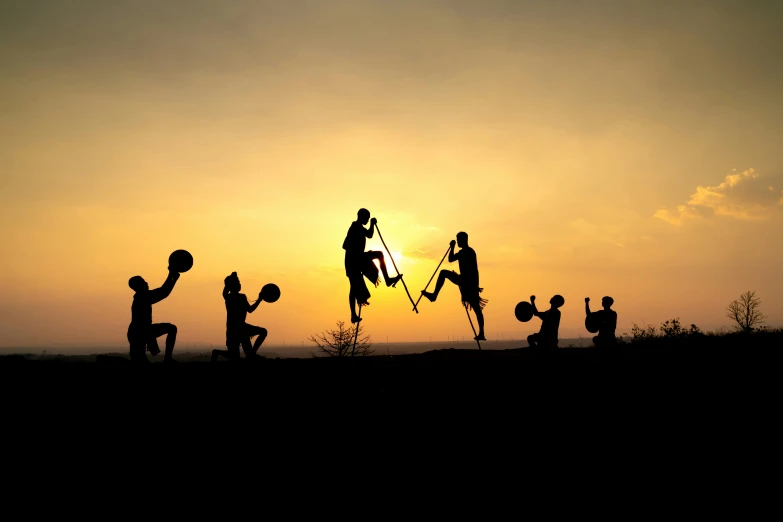 a group of people standing around a field holding their hands