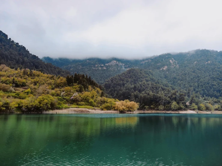 a calm lake in the middle of a mountainous area