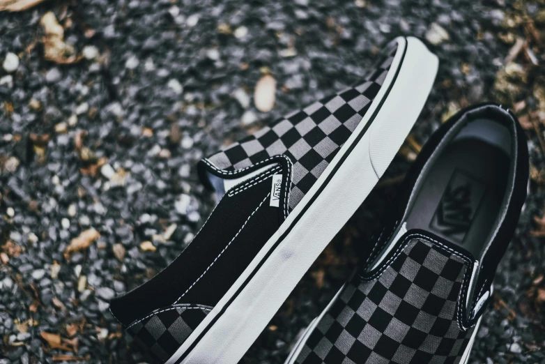two black and white checkered vans are shown