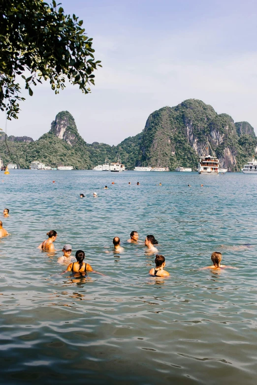 several people are floating and swimming in the water