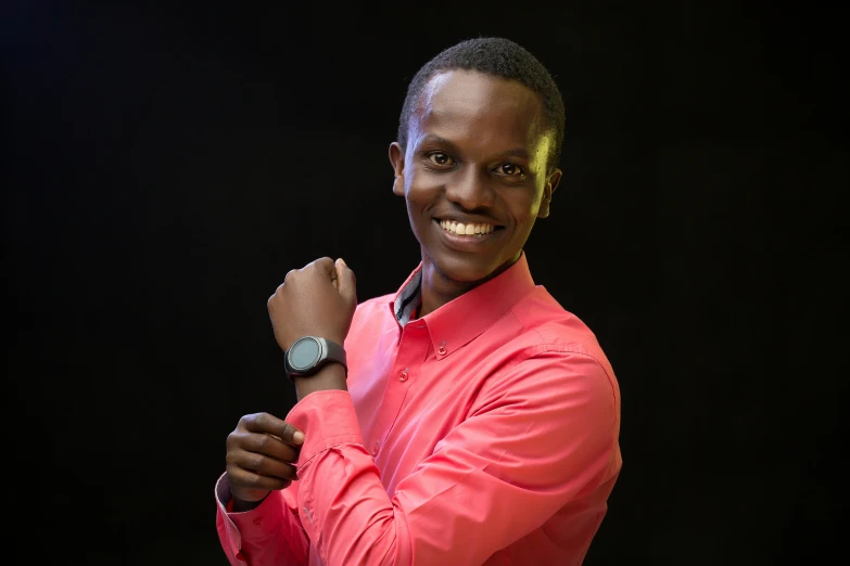 a man standing while wearing a bright pink shirt