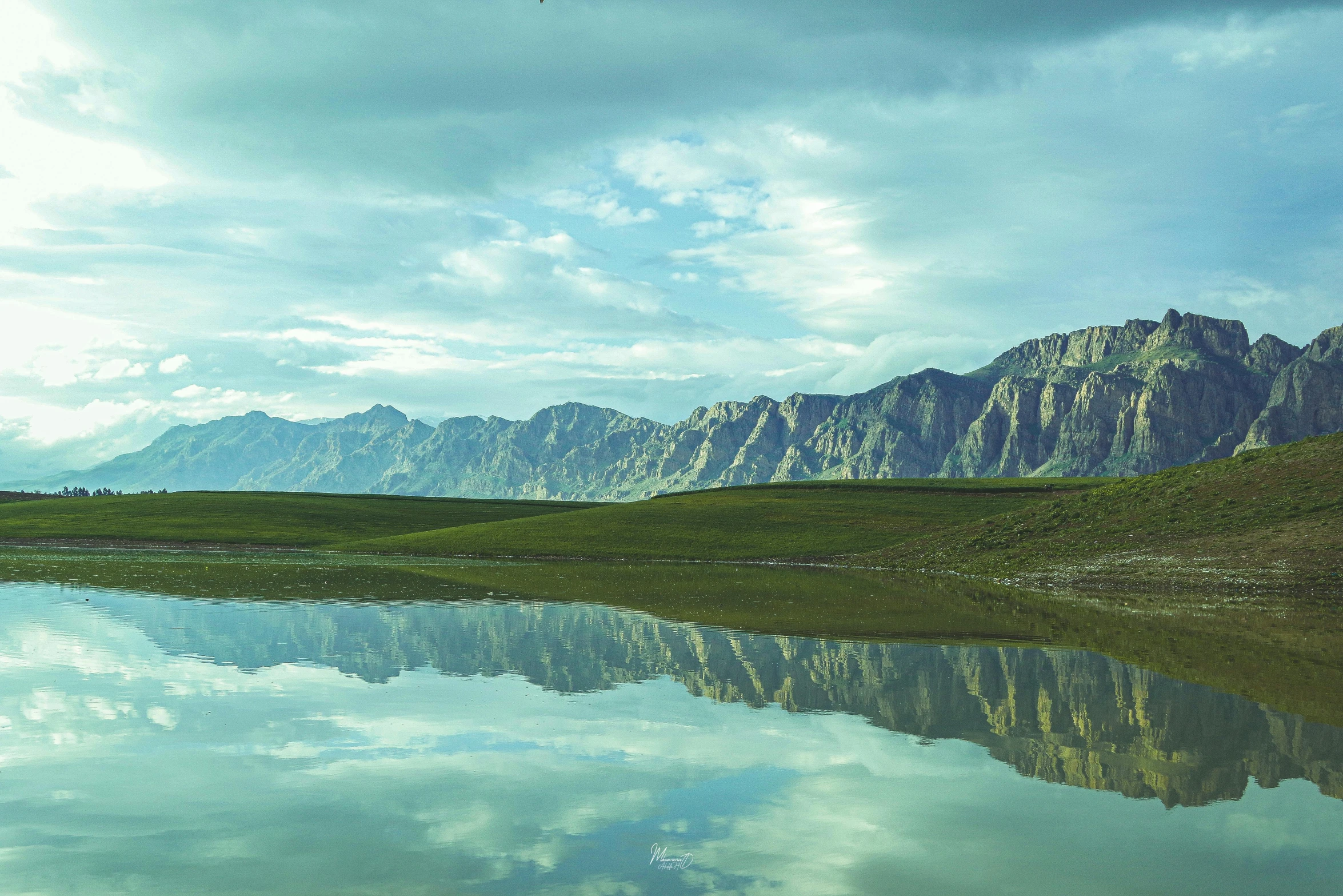 a large lake in front of some mountains