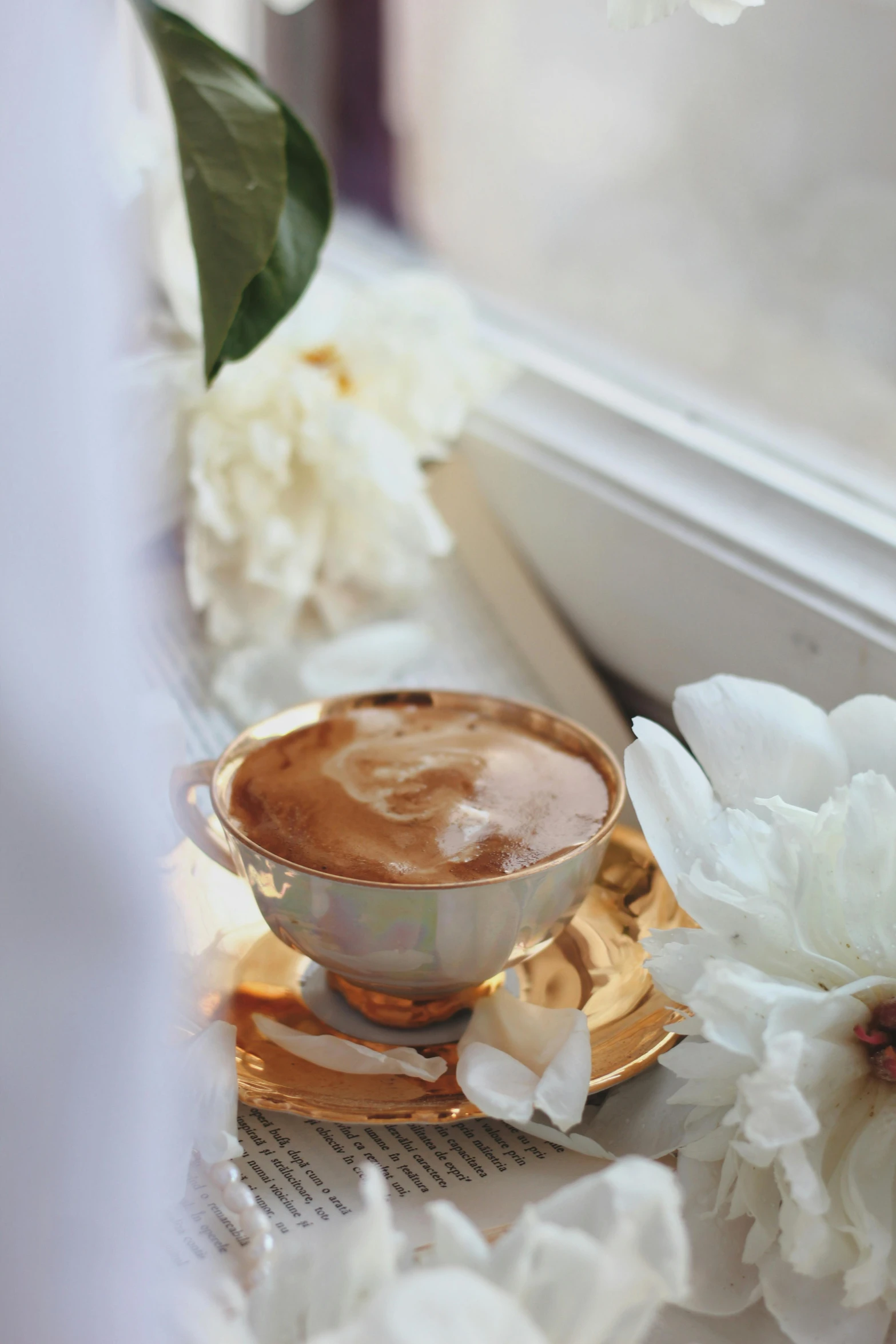 a white flower sits on a golden saucer