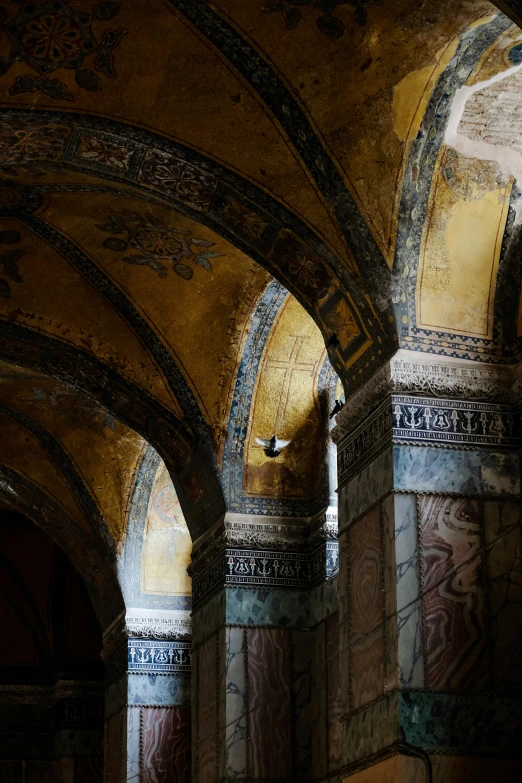 ornately designed stone arches are visible inside a medieval building