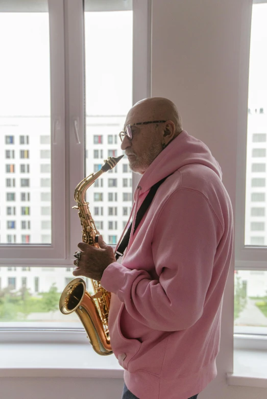 a man that is standing up and playing the saxophone