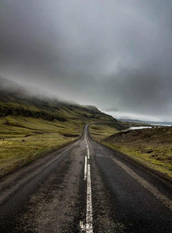 a lone car driving down a gravel road